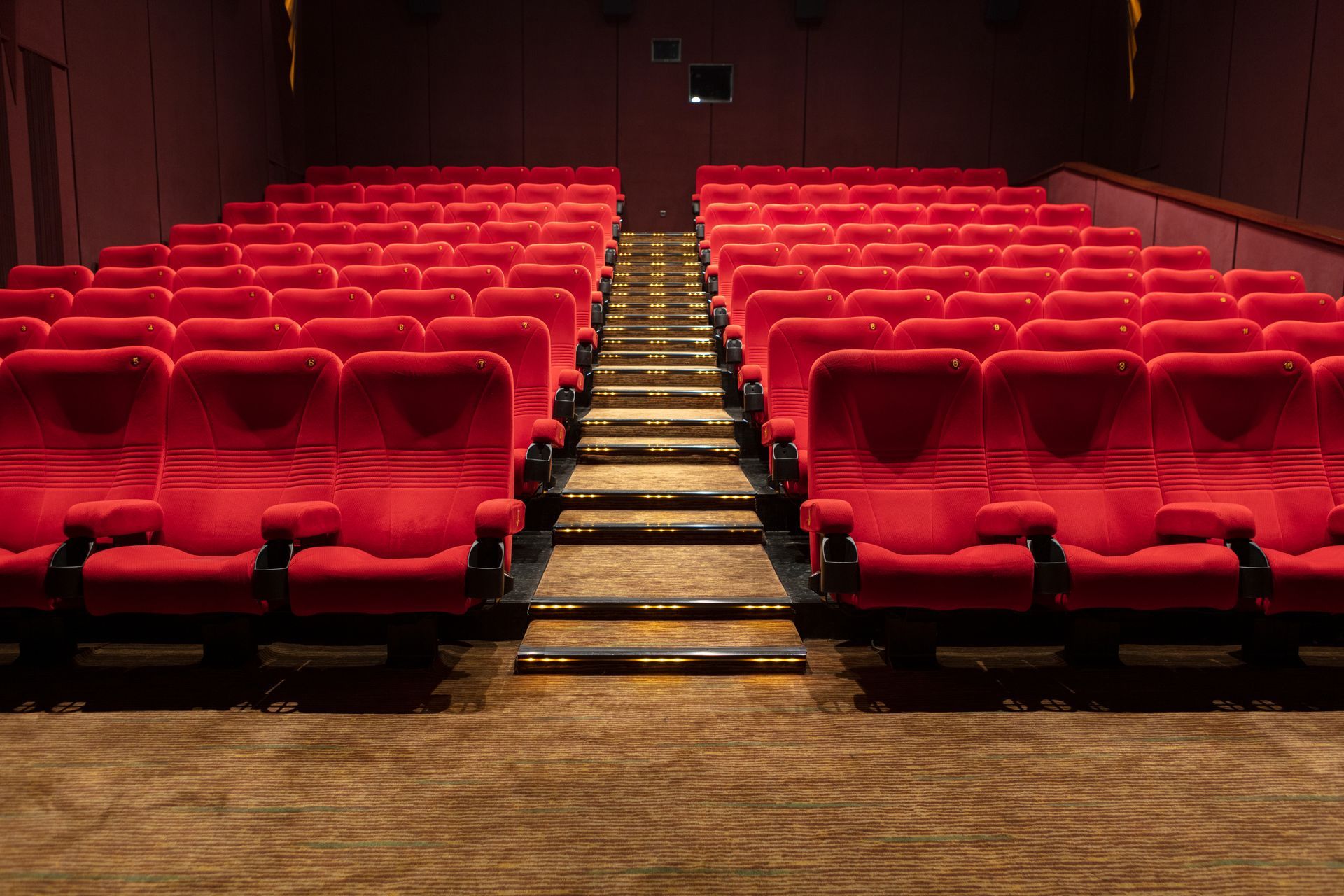Des sièges et une moquette dans une salle de cinéma
