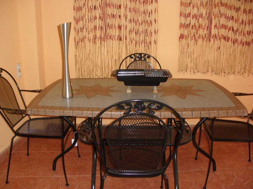 Una mesa de comedor con un jarrón encima.