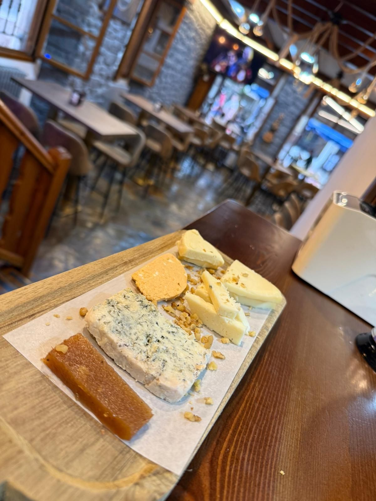 Una bandeja de comida está sobre una mesa de madera en un restaurante.
