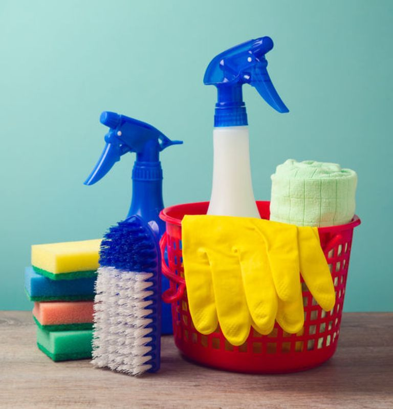 Una mujer está limpiando una mesa de madera con un paño.