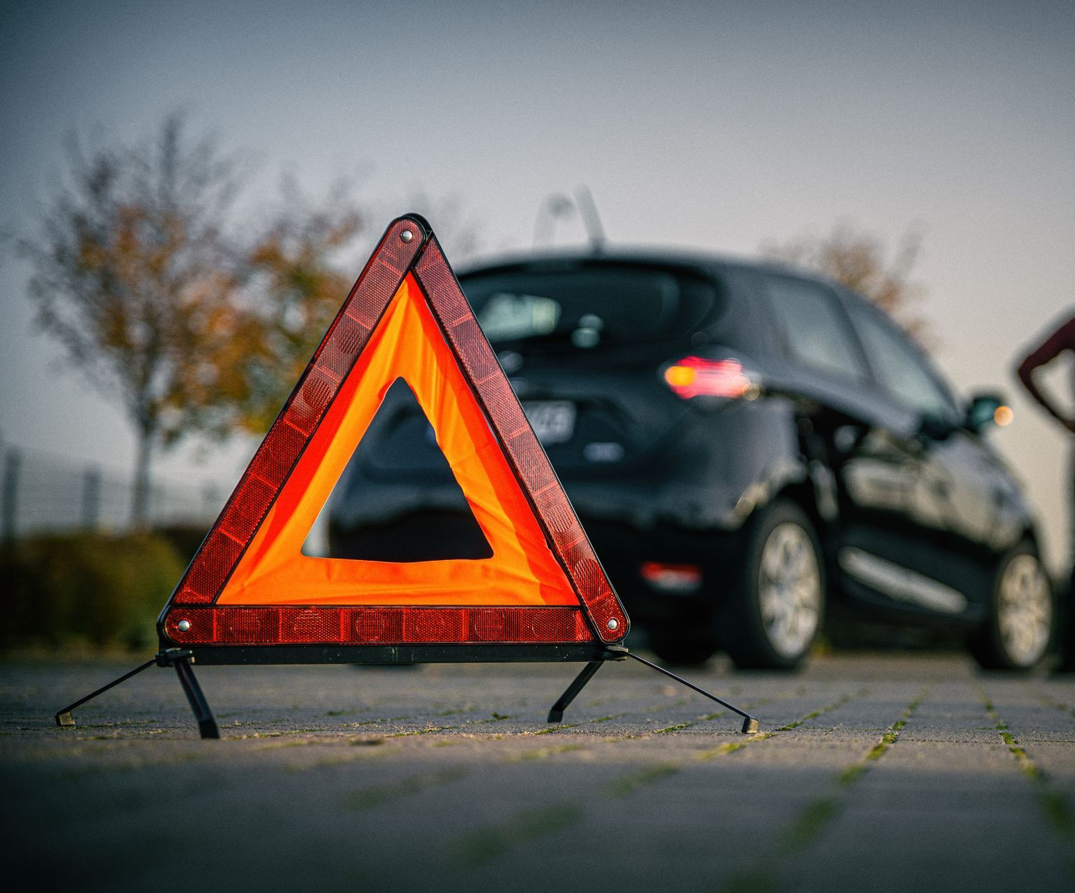Un triangle de sécurité devant une voiture en panne