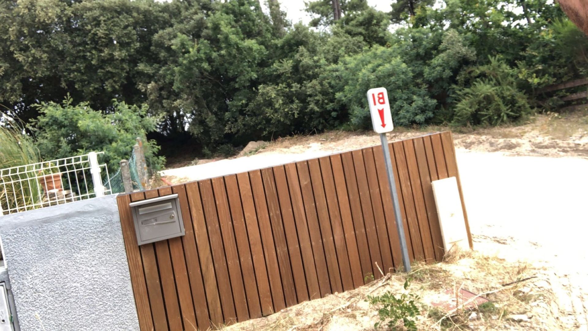 Mise en place d'une palissade en bois et d'une boîte aux lettres