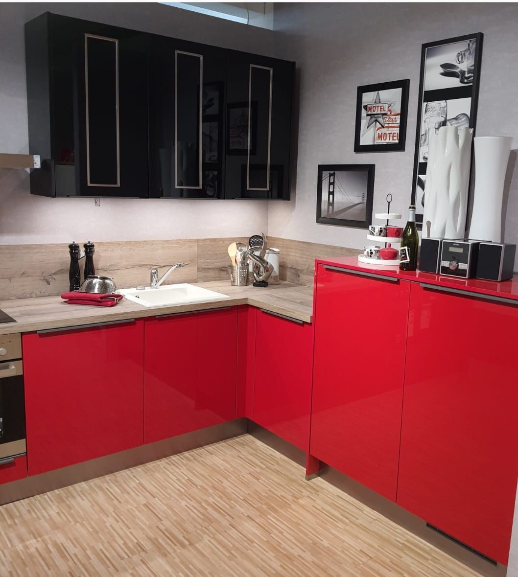 Eine Küche mit roten und schwarzen Schränken