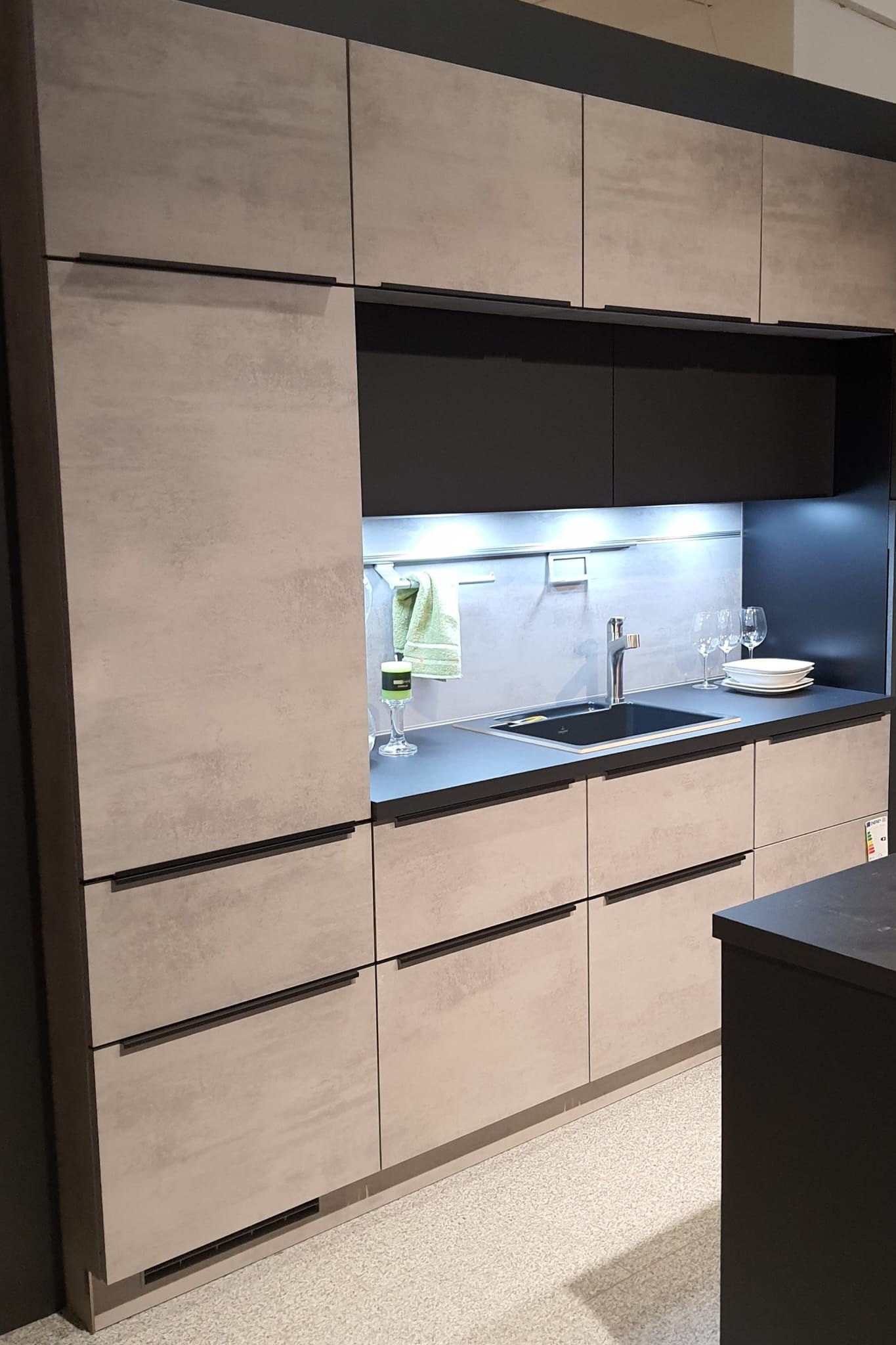 Eine Küche mit Holzschränken und einer schwarzen Arbeitsplatte.