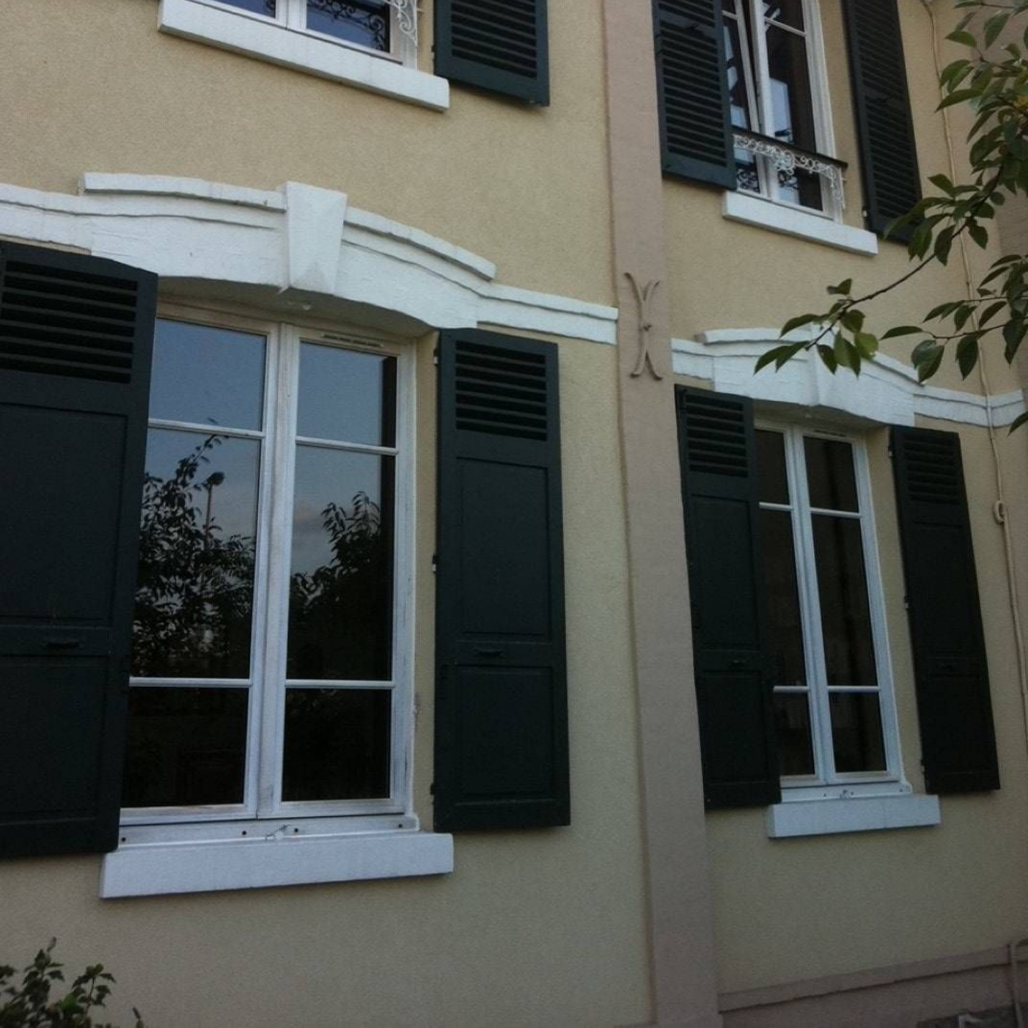 Maison avec plusieurs fenêtres et volets