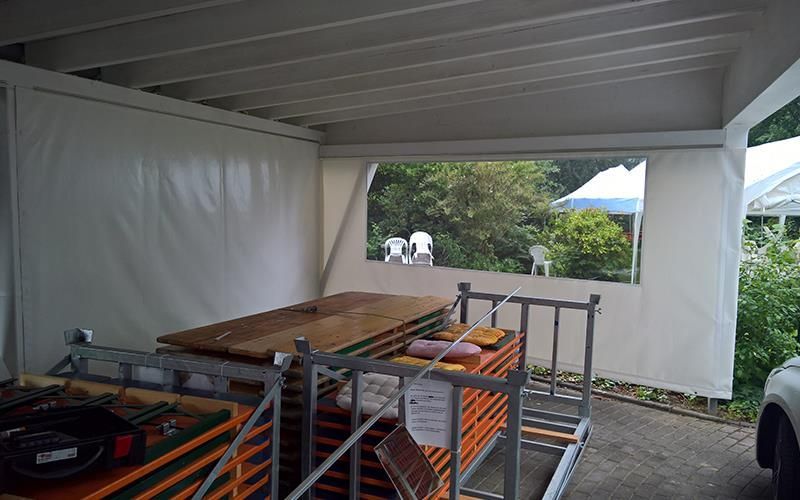 Ein weißes Zelt mit einem Tisch und Stühlen darin