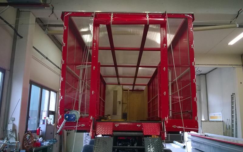 In einer Garage wird ein roter LKW gebaut.