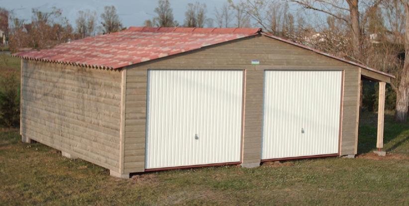 Un garage avec des portes blanches, un toit en tuiles