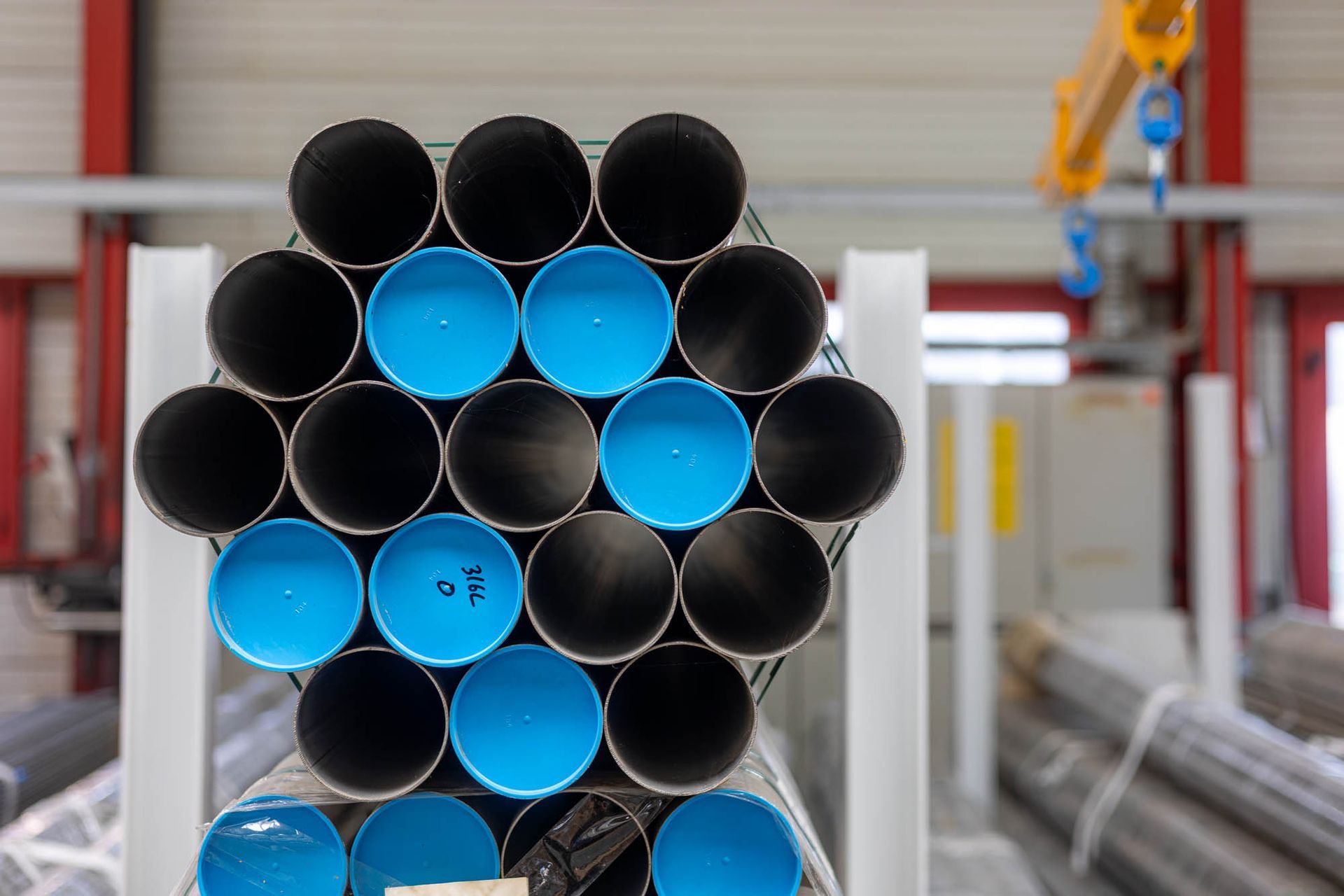 In einer Fabrik sind mehrere Rohre übereinander gestapelt.