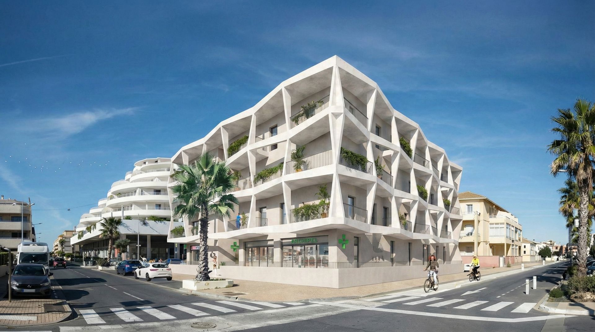 Immeuble d'appartements blanc moderne à l'angle d'une rue, avec balcons et palmiers. Ciel bleu.