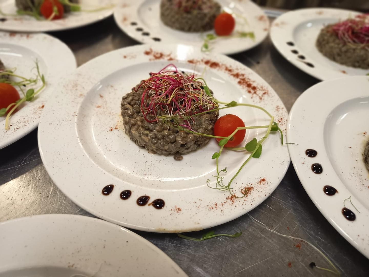 Tartelettes aux champignons gastronomiques présentées sur des assiettes blanches.