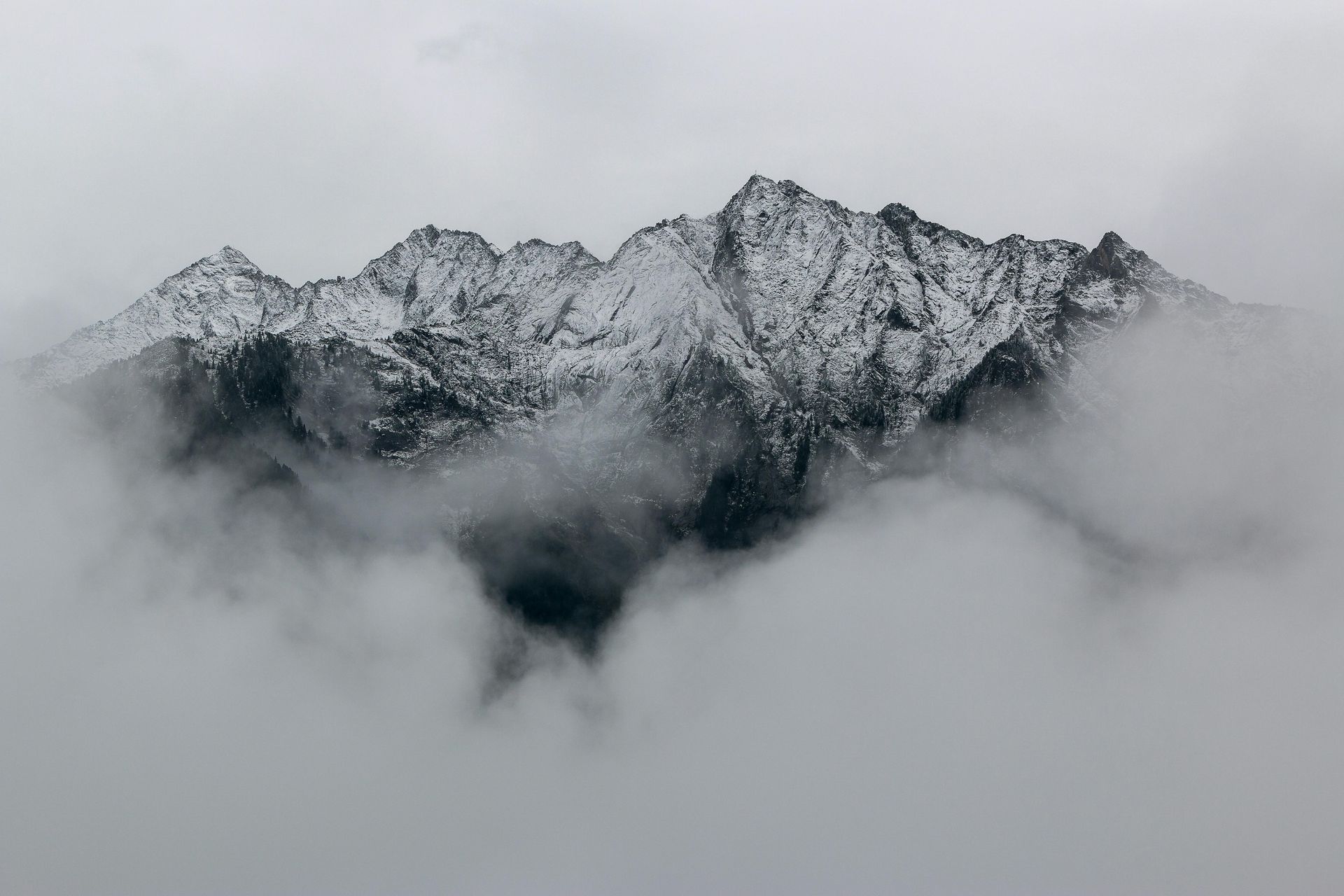 snow peaks with clouds below