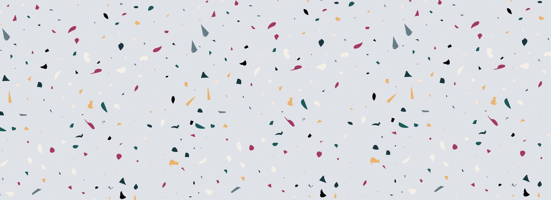 Confettis colorés éparpillés sur un fond gris clair