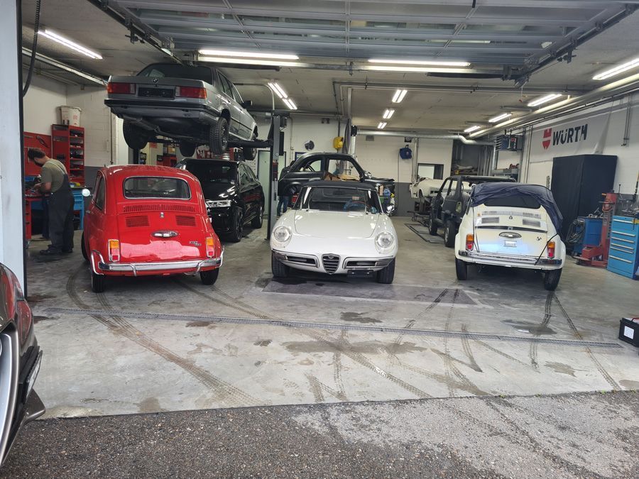 Eine Gruppe von Autos ist in einer Garage geparkt.