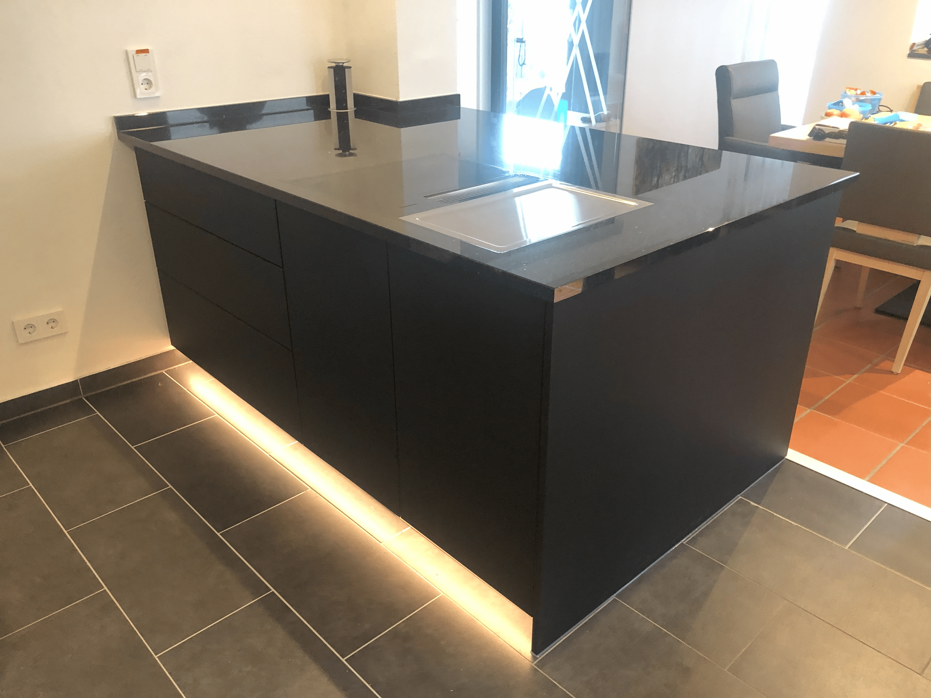 Eine Küche mit einer großen Kochinsel und einem Herd mit Backofen.