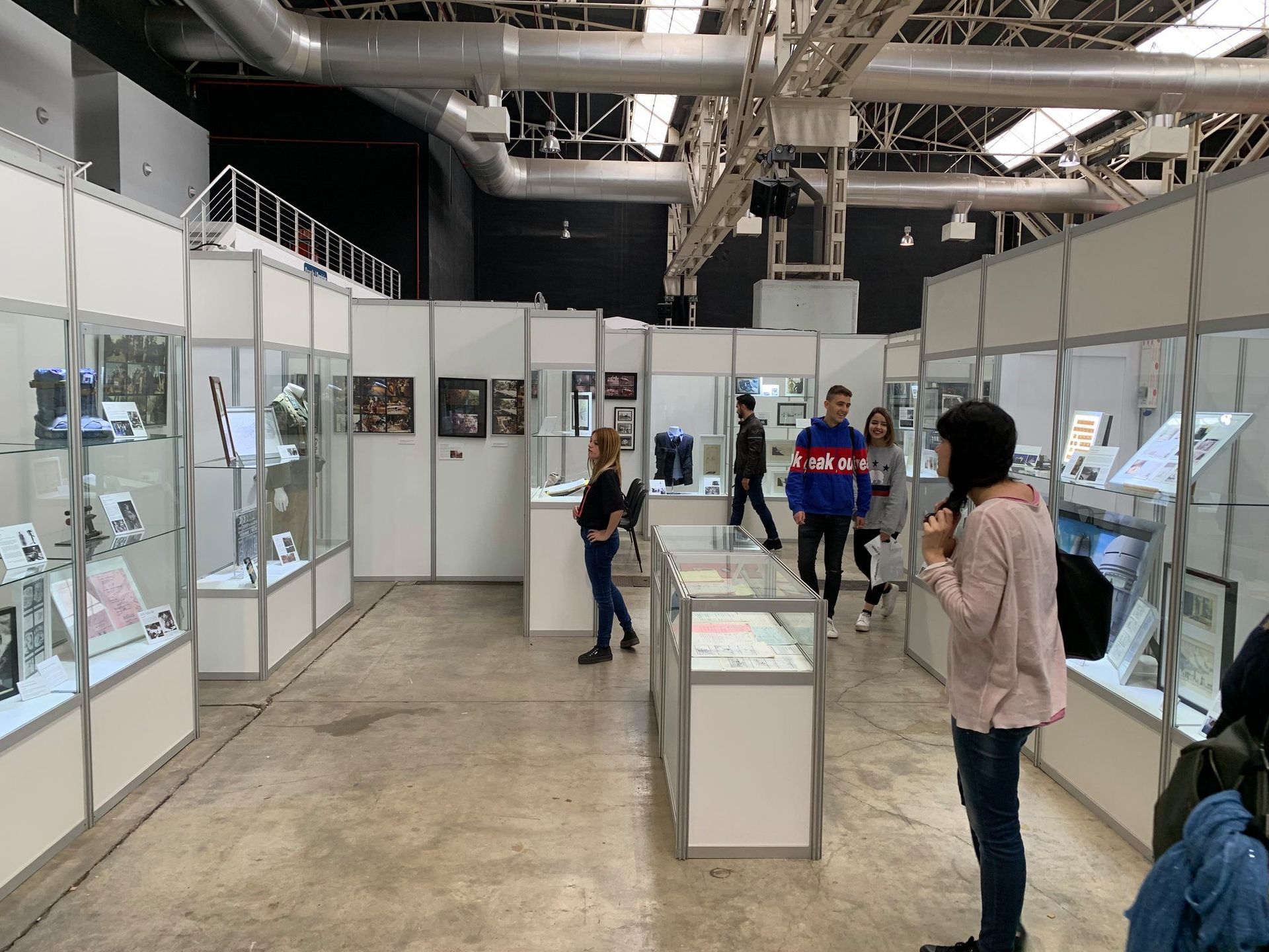 Un grupo de personas se encuentra en un museo mirando exhibiciones.