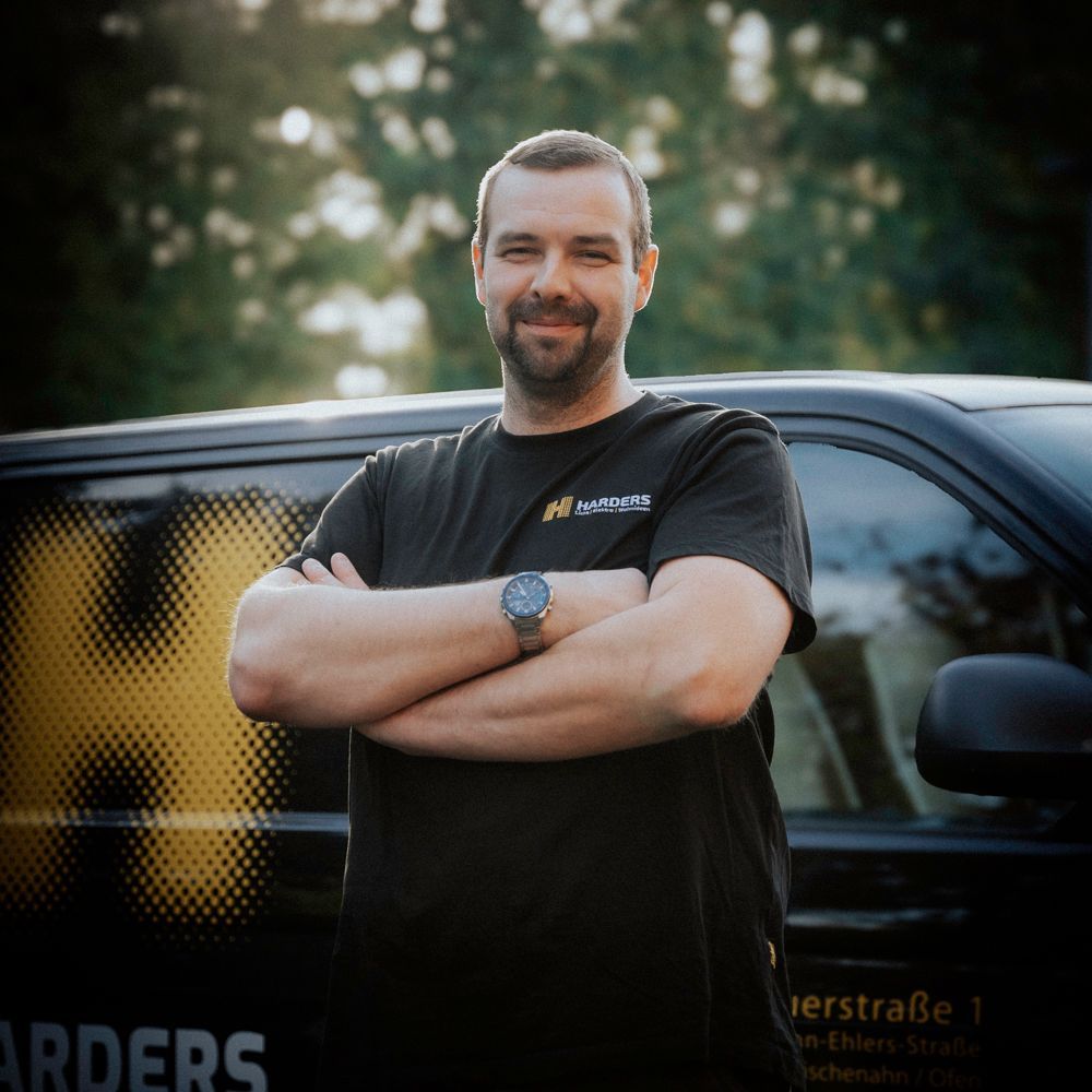 Ein Mann in einem schwarzen Hemd mit der Aufschrift „Harders“ darauf