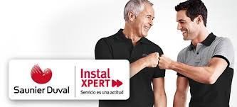 Dos hombres chocando los puños. Se muestran los logotipos de Saunier Duval e Instal XPERT.