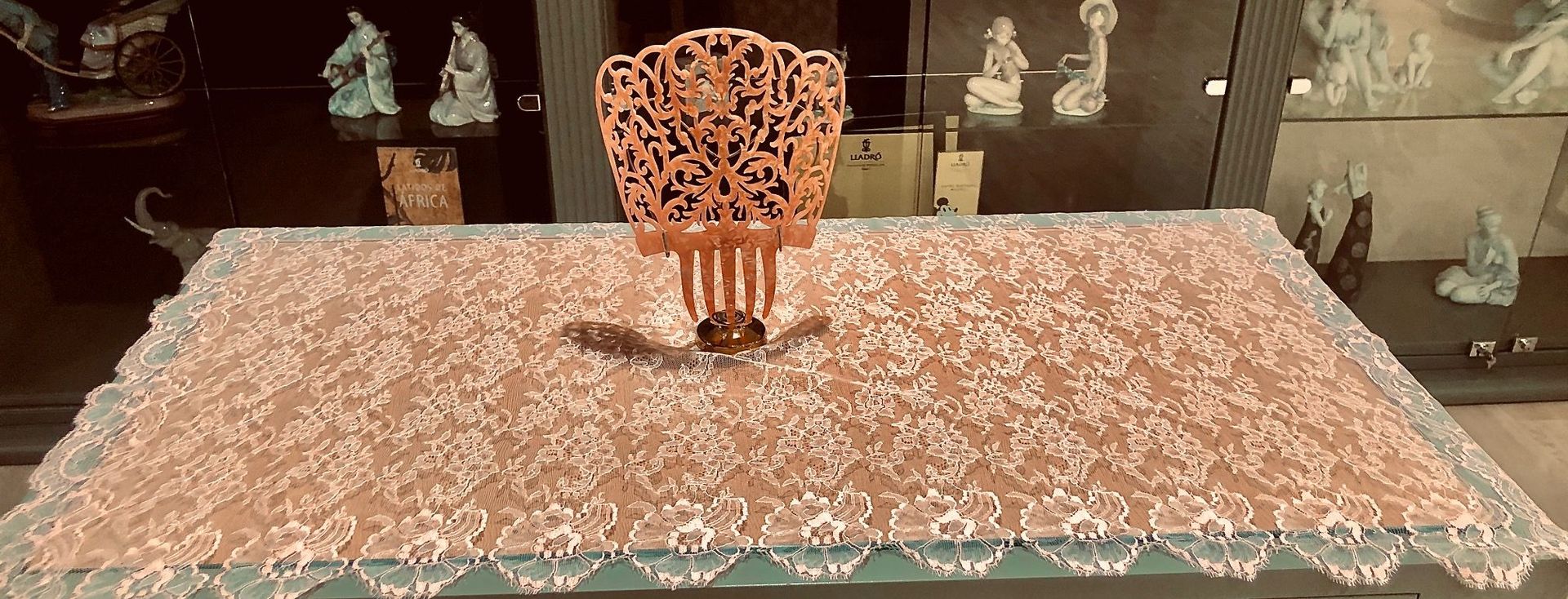 Una mesa con un mantel de encaje y un peine encima.