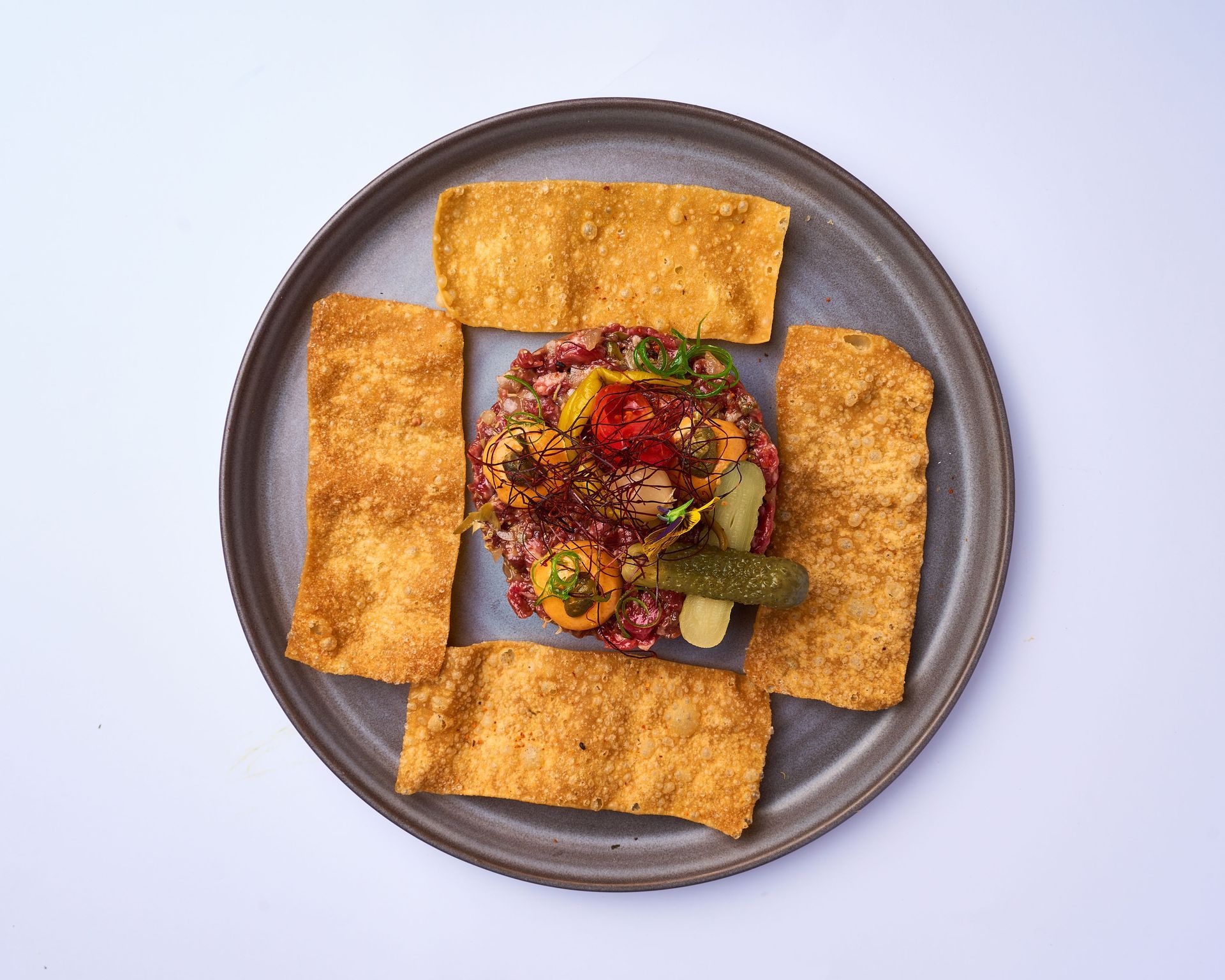 Un sándwich y pan de ajo están sobre una tabla de cortar de madera.