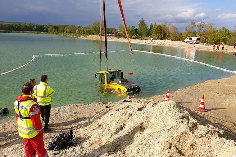 Radlader wird von Kran Völkl aus einem See geborgen