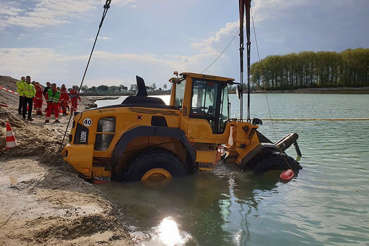 Radlader wird von Kran Völkl aus einem See geborgen