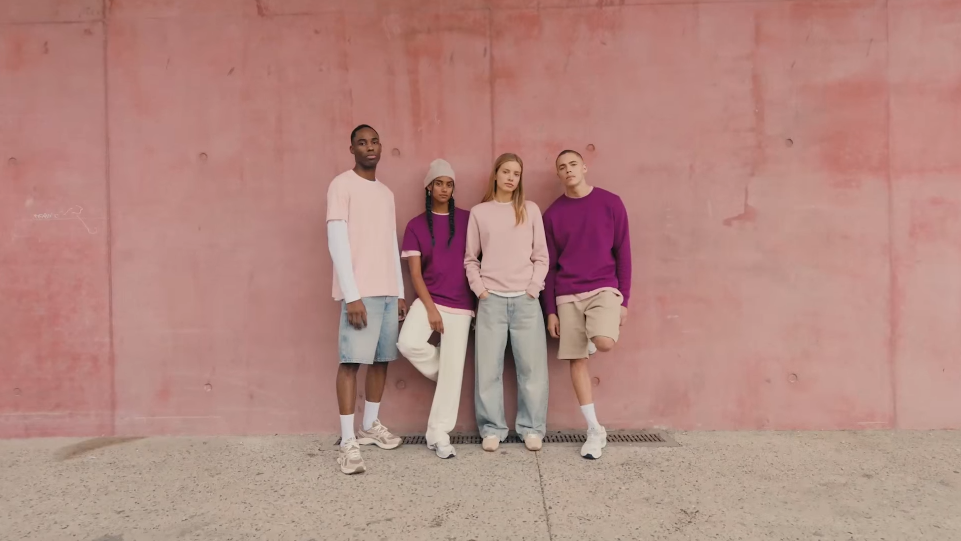 4 modèles qui posent devant un mur rose