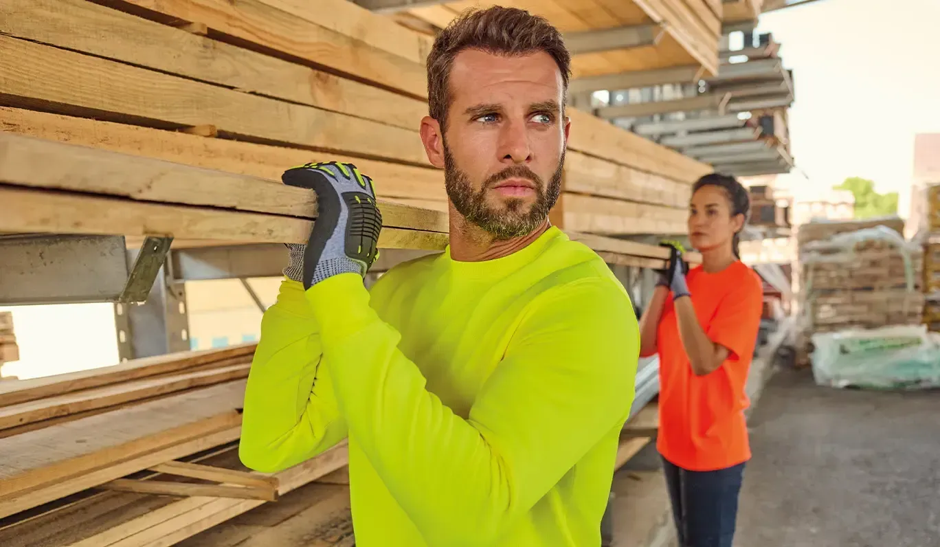 2 personnes qui portent des planches de bois