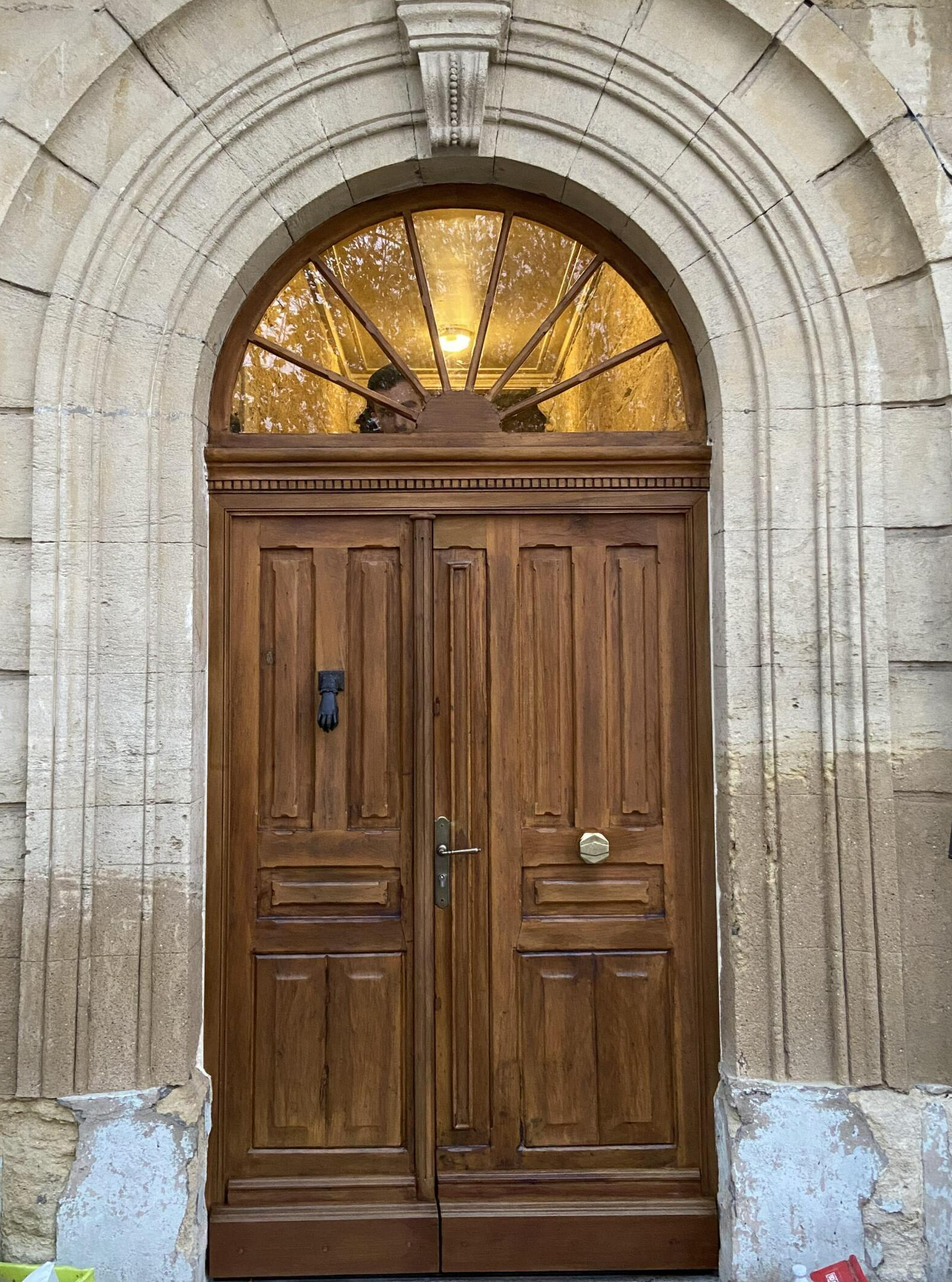 Porte d'entrée en bois avec arc en plein cintre, travail d'Arole, Nîmes