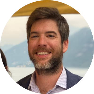 A man with a beard is smiling in a circle