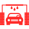 Un coche rojo está siendo lavado en un lavadero de coches.