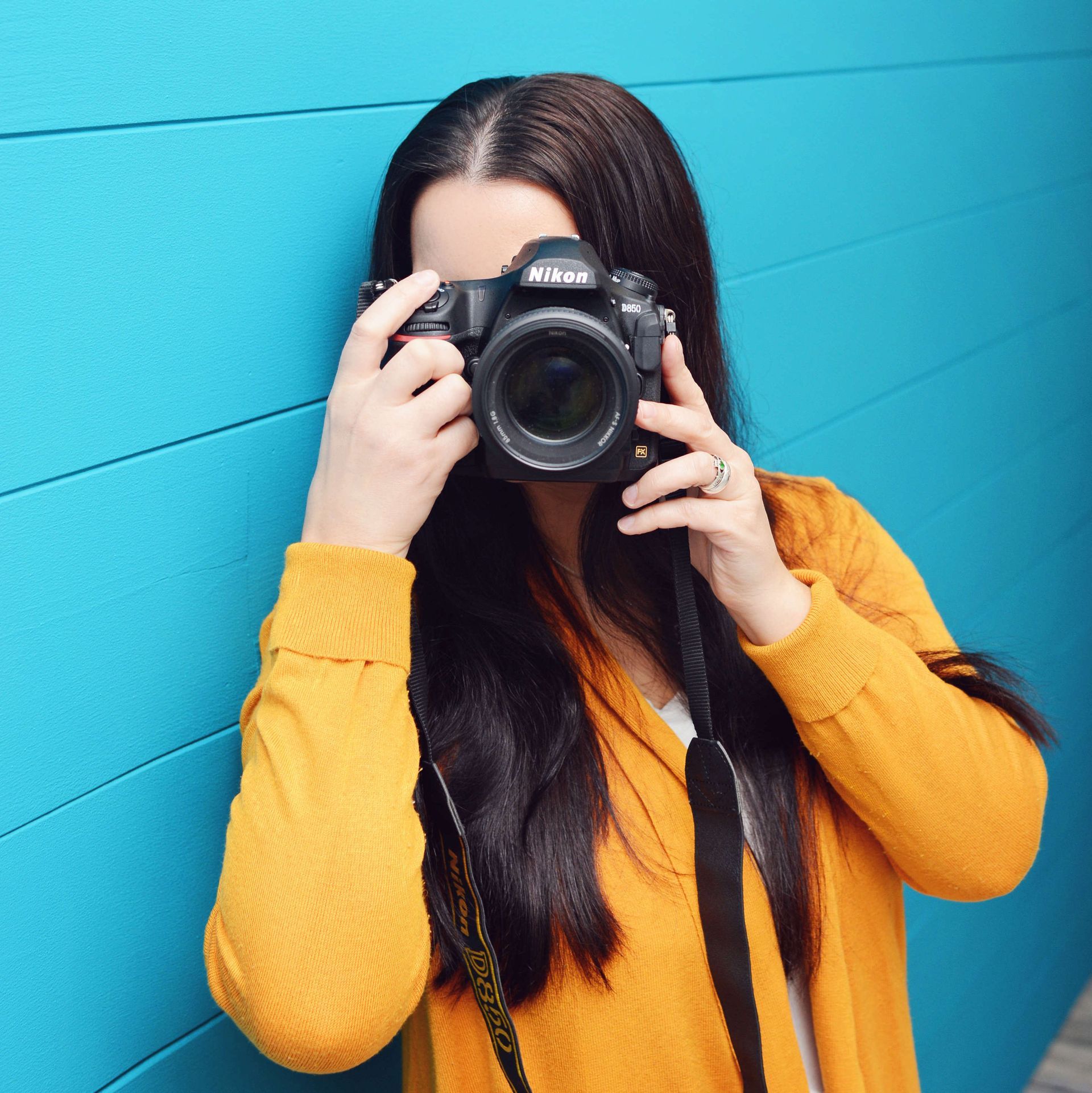 Eine Frau, die mit einer Nikon-Kamera ein Foto macht