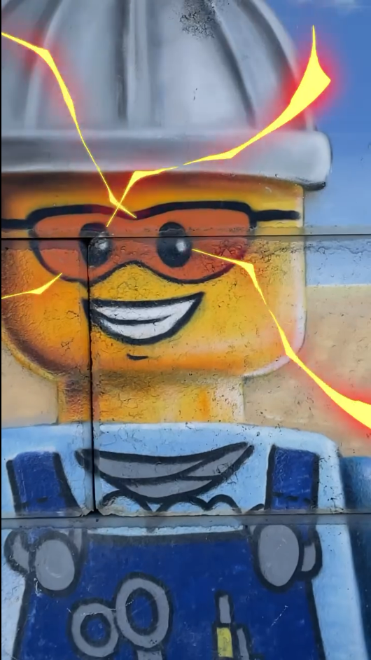 Fresque d'un mur de Drive Béton avec un personnage Lego