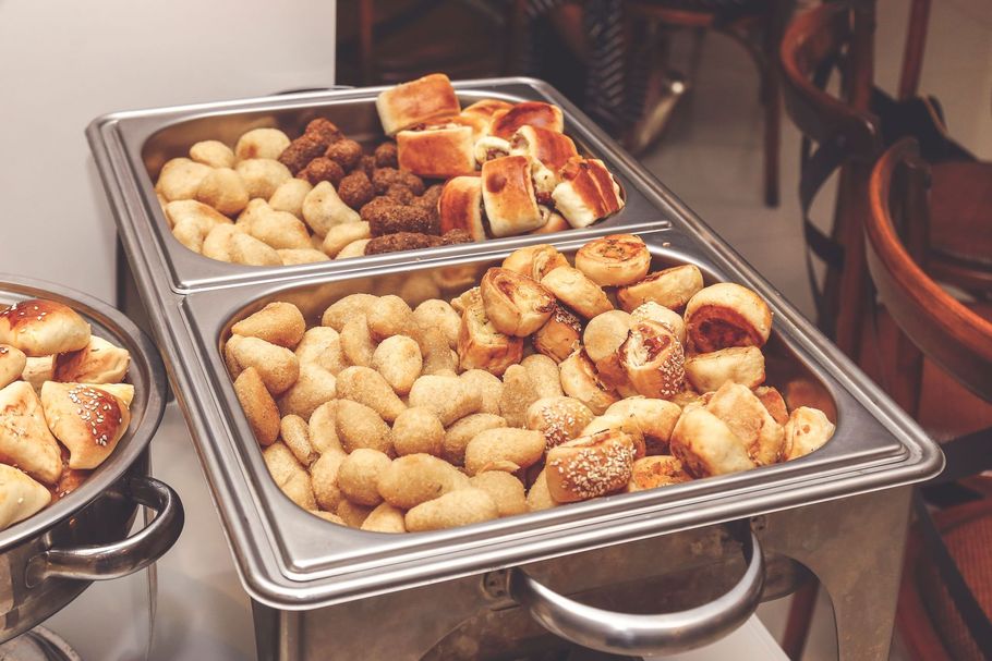 Plateau de viennoiseries et de petits pains assortis sur une table de buffet