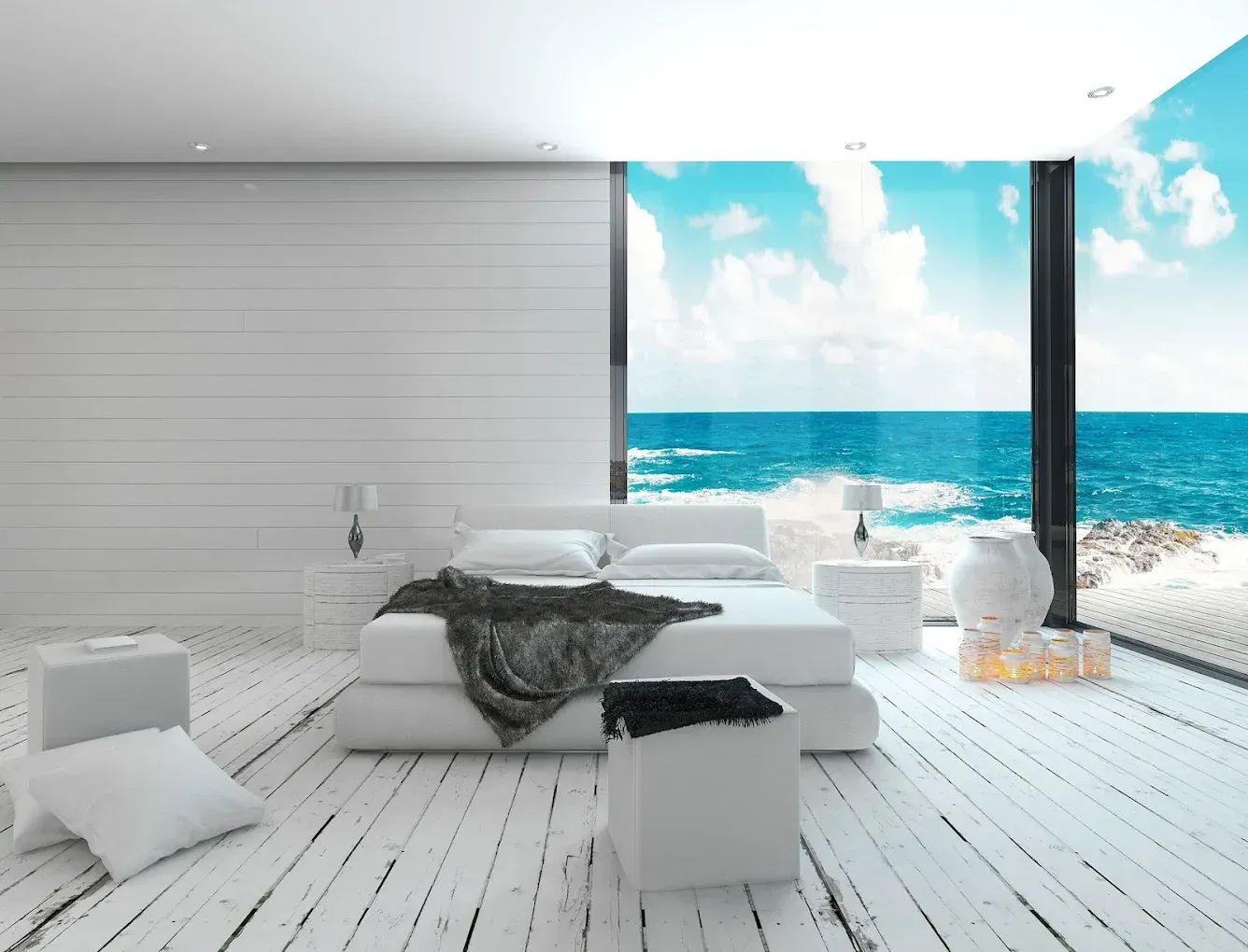 Dormitorio blanco con gran ventanal con vistas al mar.