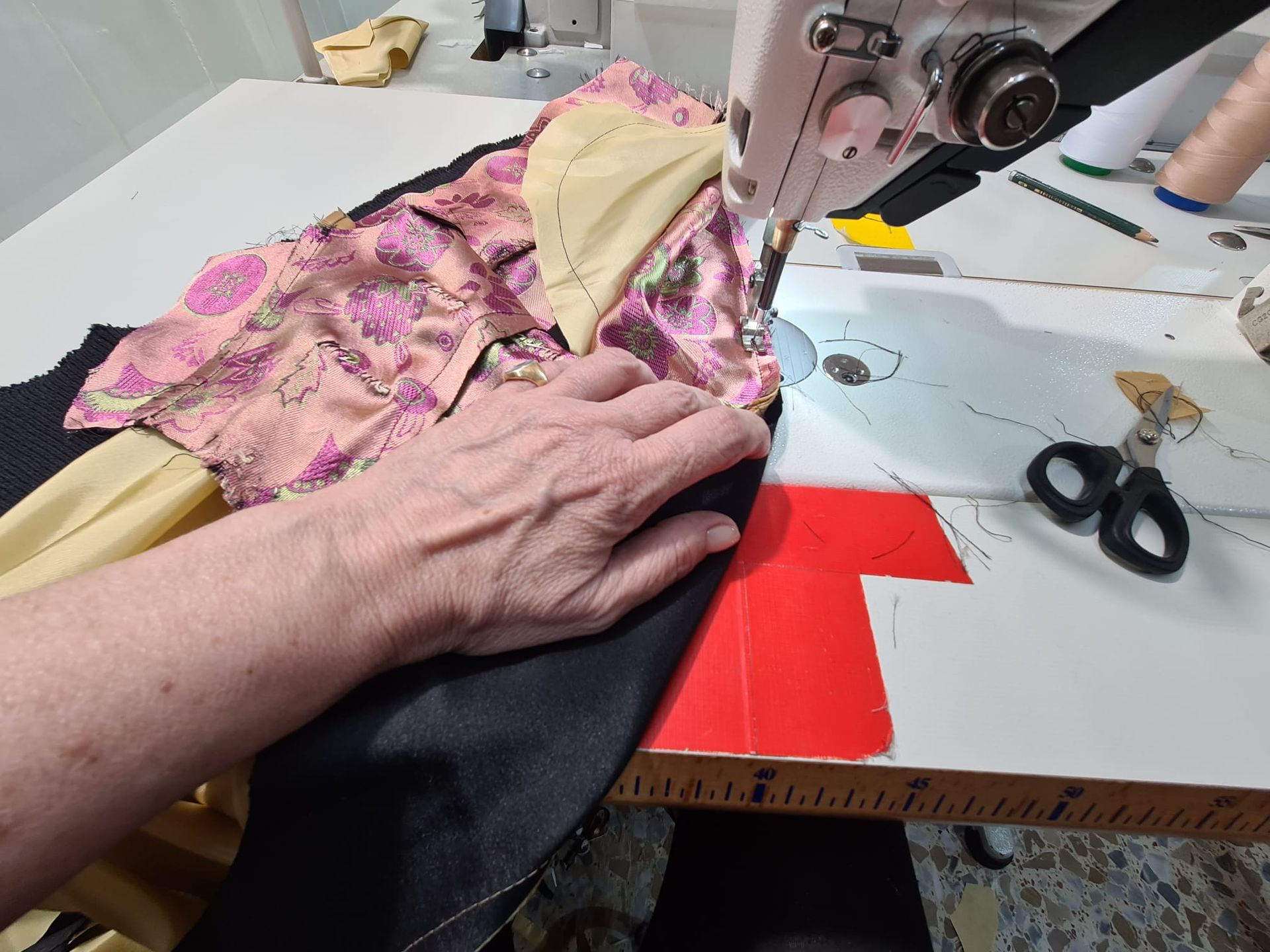 Tela cosida a mano en una máquina de coser, detalles de la construcción del vestido.