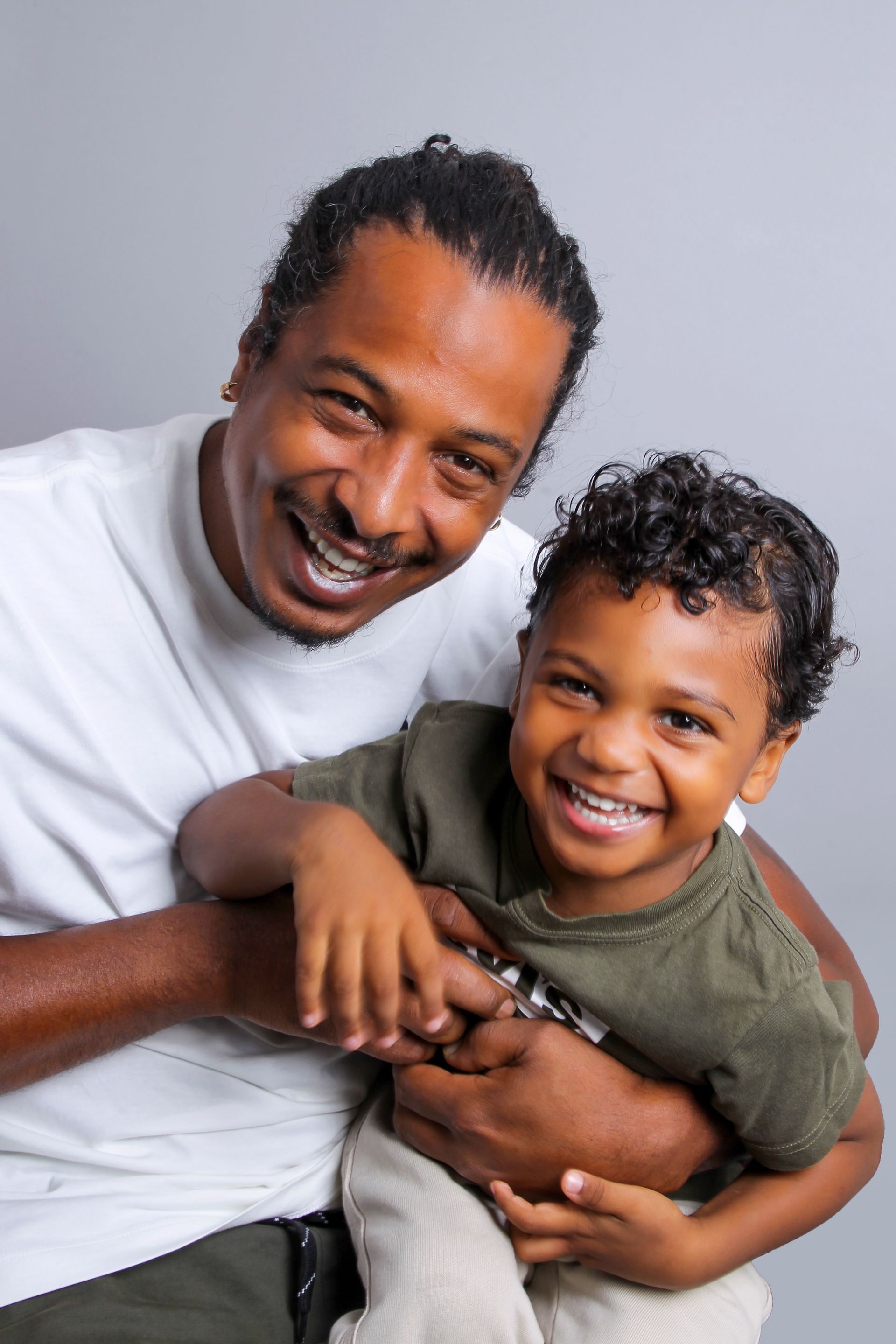 Portrait d'un jeune papa avec son fils dans ses bras