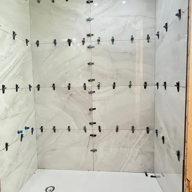 Un baño con muchos azulejos que se están instalando.