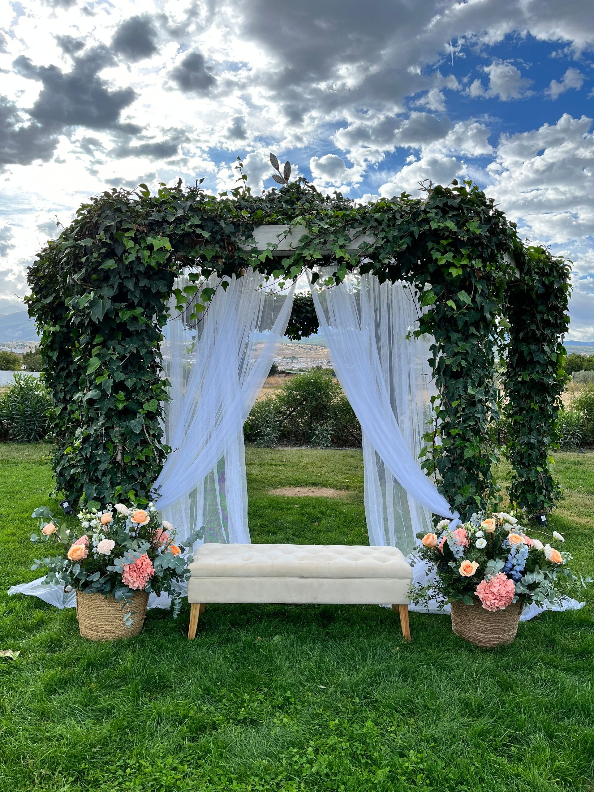 Un banco está sentado bajo un dosel en el césped.