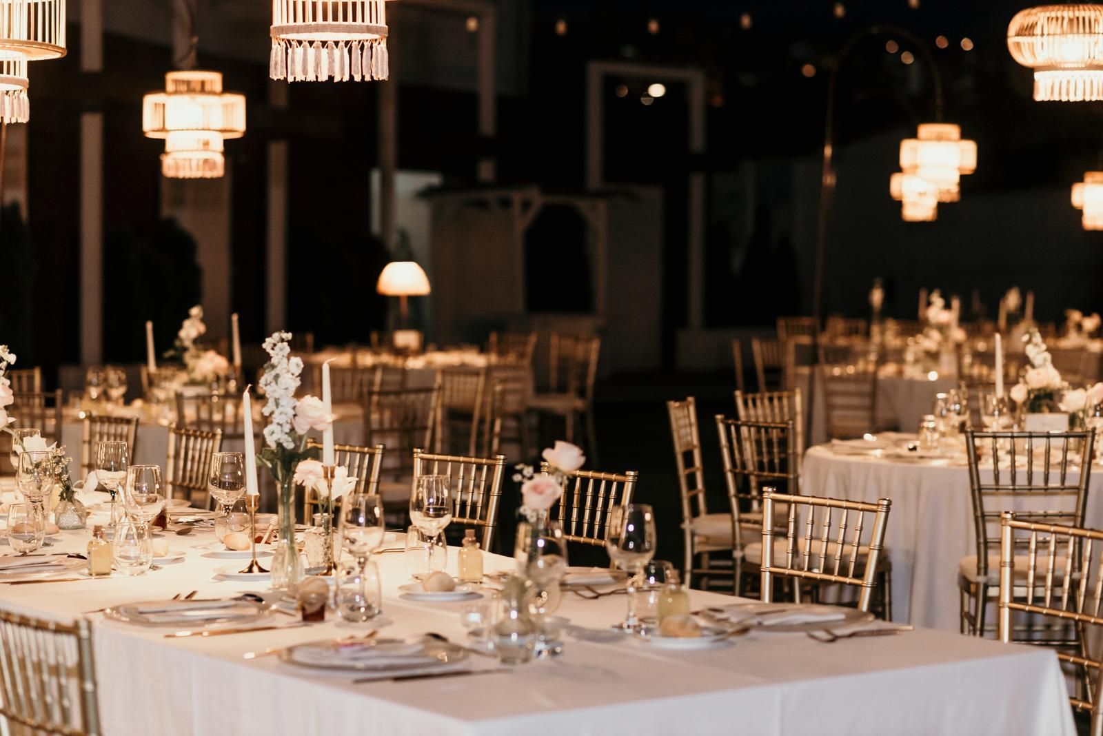 Una gran sala con mesas y sillas preparadas para una recepción de boda.