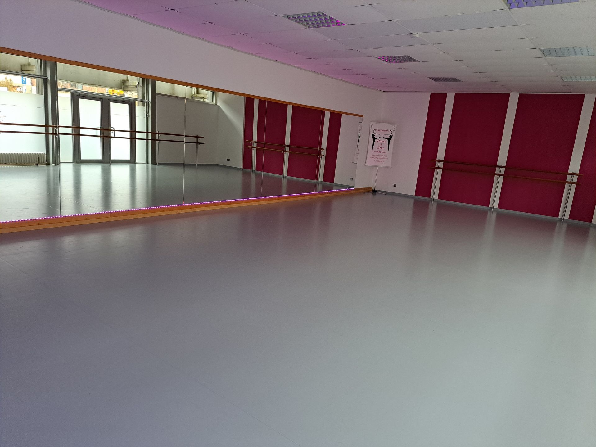 Leerer Tanzsaal mit Spiegelwand und rotem Vorhang