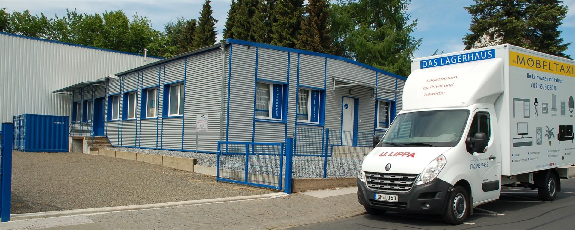 Ein weißer Lieferwagen steht vor einem Gebäude