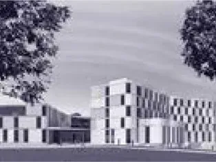 Ein großes Gebäude mit vielen Fenstern und einer Straßenlaterne davor.