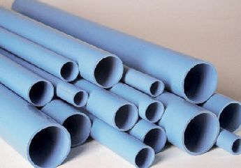 Un montón de tubos azules están apilados uno encima del otro sobre una mesa.