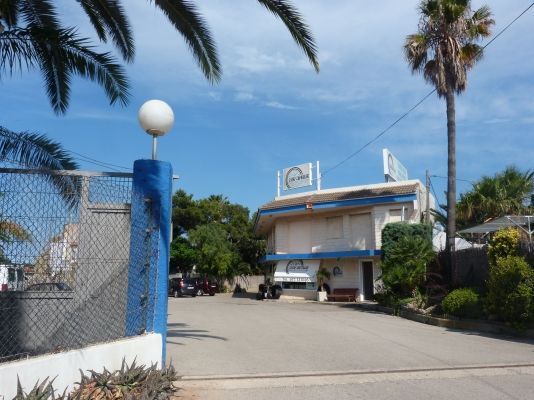 Un edificio azul y blanco con un reloj encima.