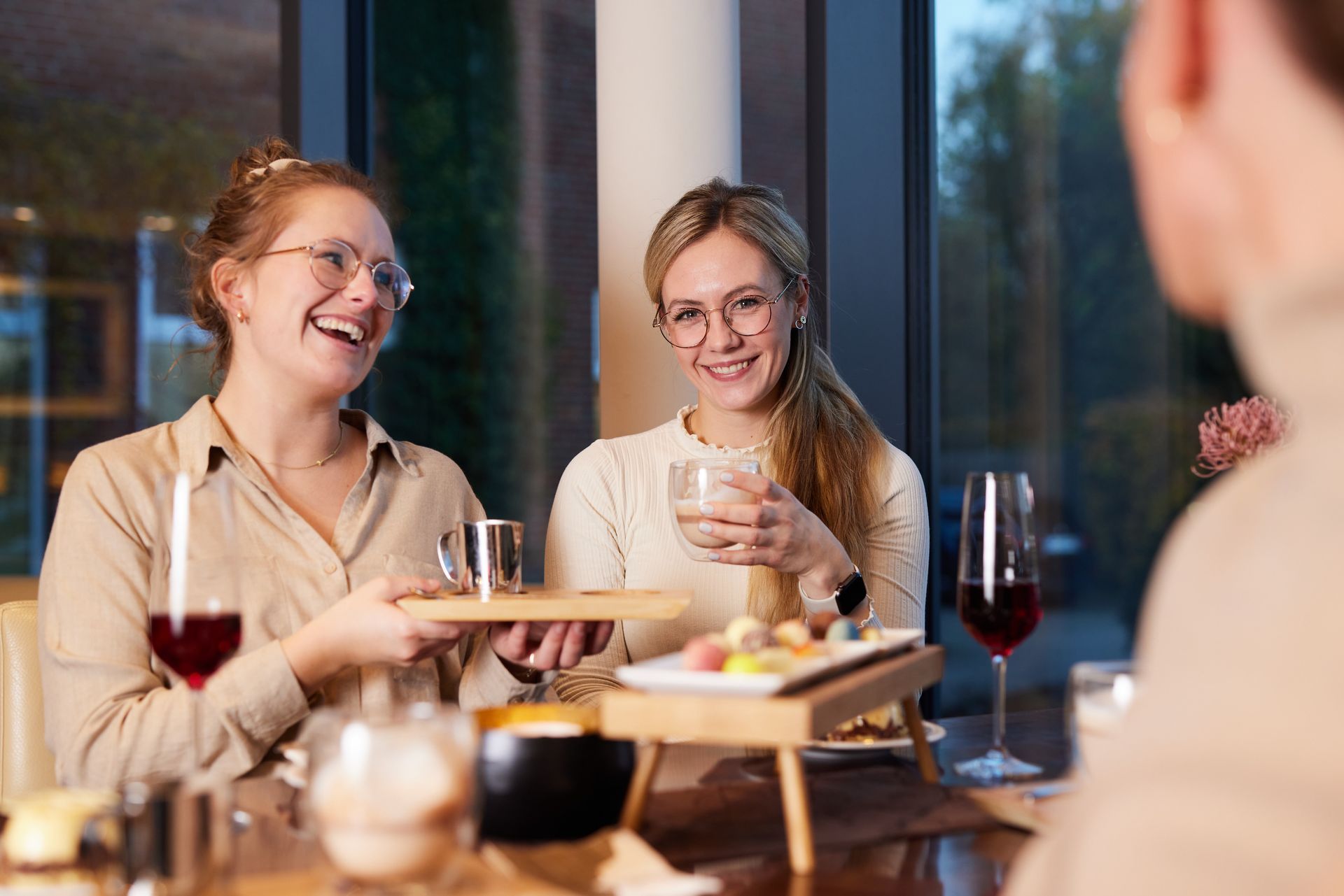 two women enjoying chocolates, hot chocolate, and Choco Rosso in the chocolate lounge