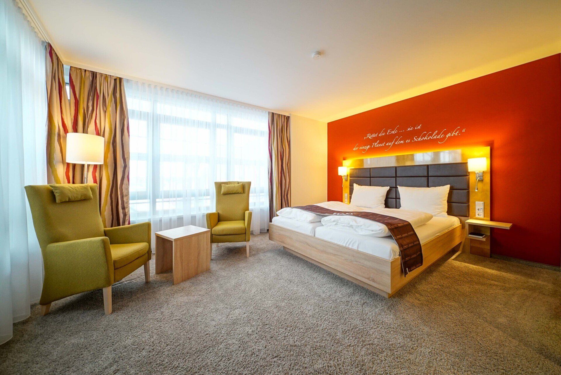 Ein Hotelzimmer mit einem Bett, Stühlen und einem Tisch.