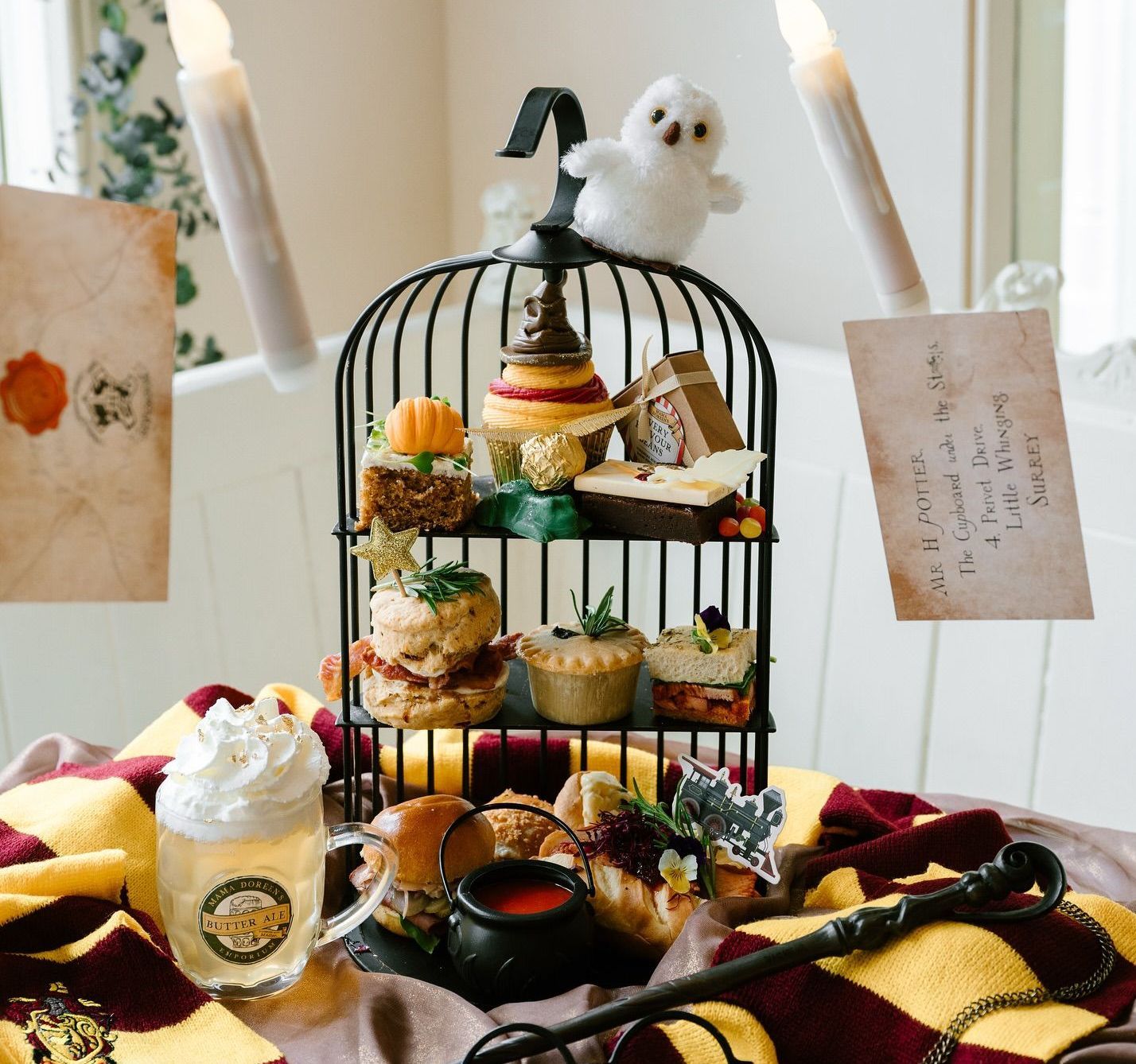 A bird cage filled with food and a card that says ' harry potter ' on it
