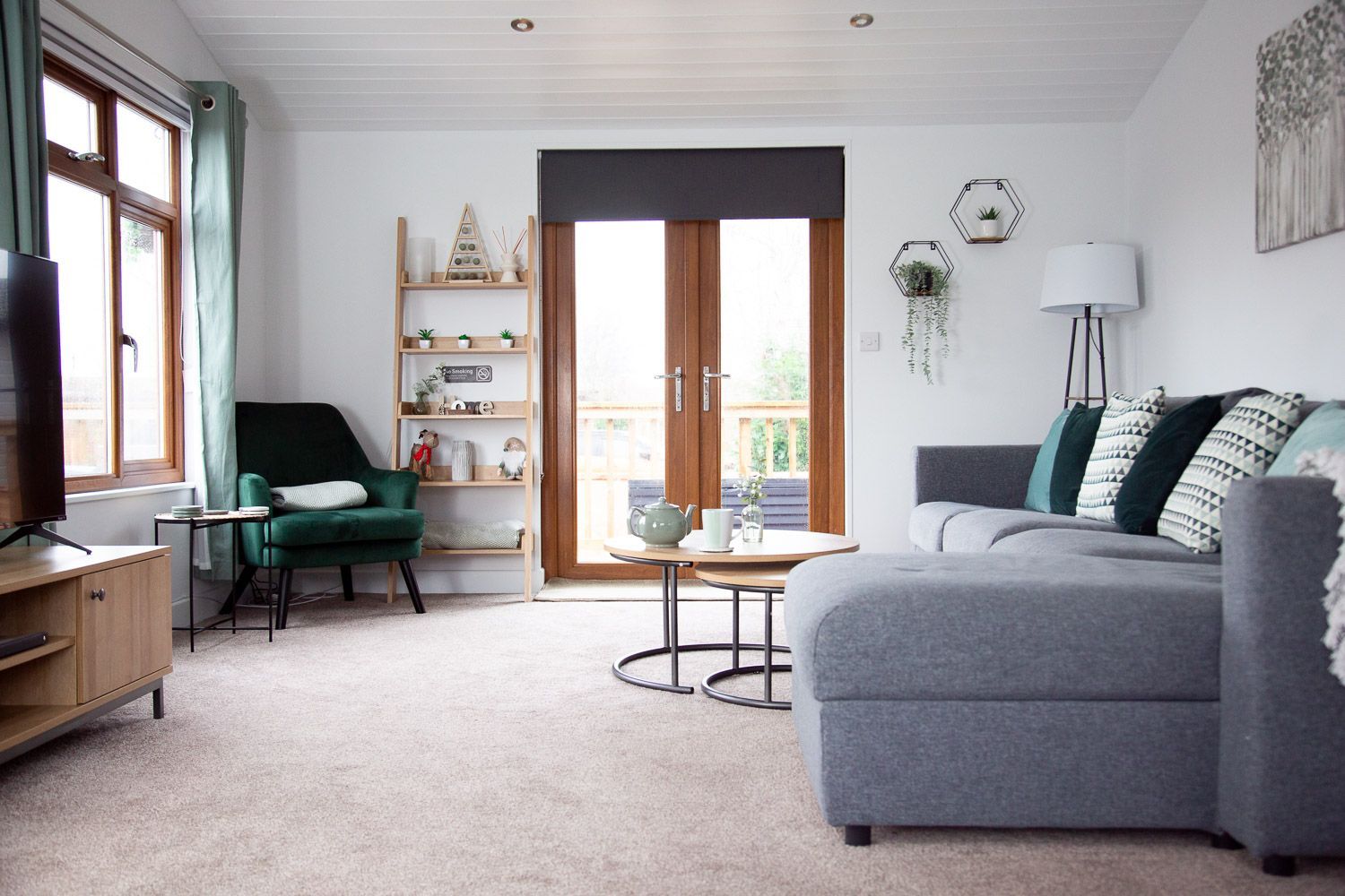 A living room with a couch , chair , table and television.