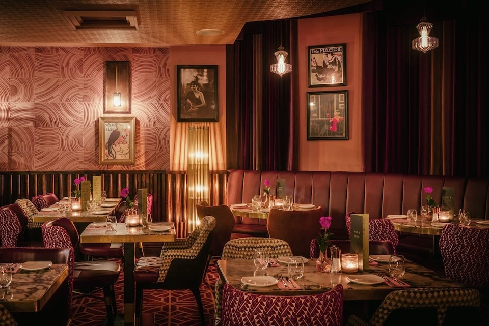 A dining room with tables and chairs in a restaurant.